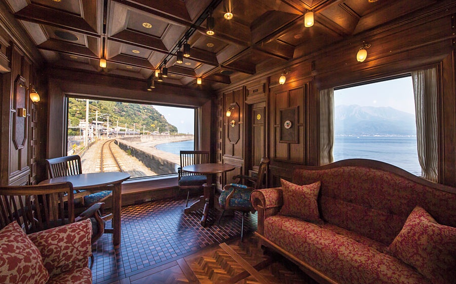 Japan's Kyushu Seven Stars luxury train includes 12 suites, 2 deluxe suites, a diner and (above) lounge, with bar. By all accounts, the train is a work of art, boasting exquisite woods and fabrics. Kyushu Railway Photo