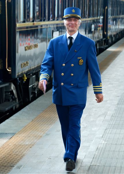A VSOE staff member prepares for boarding at Venice' Santa Lucia station.