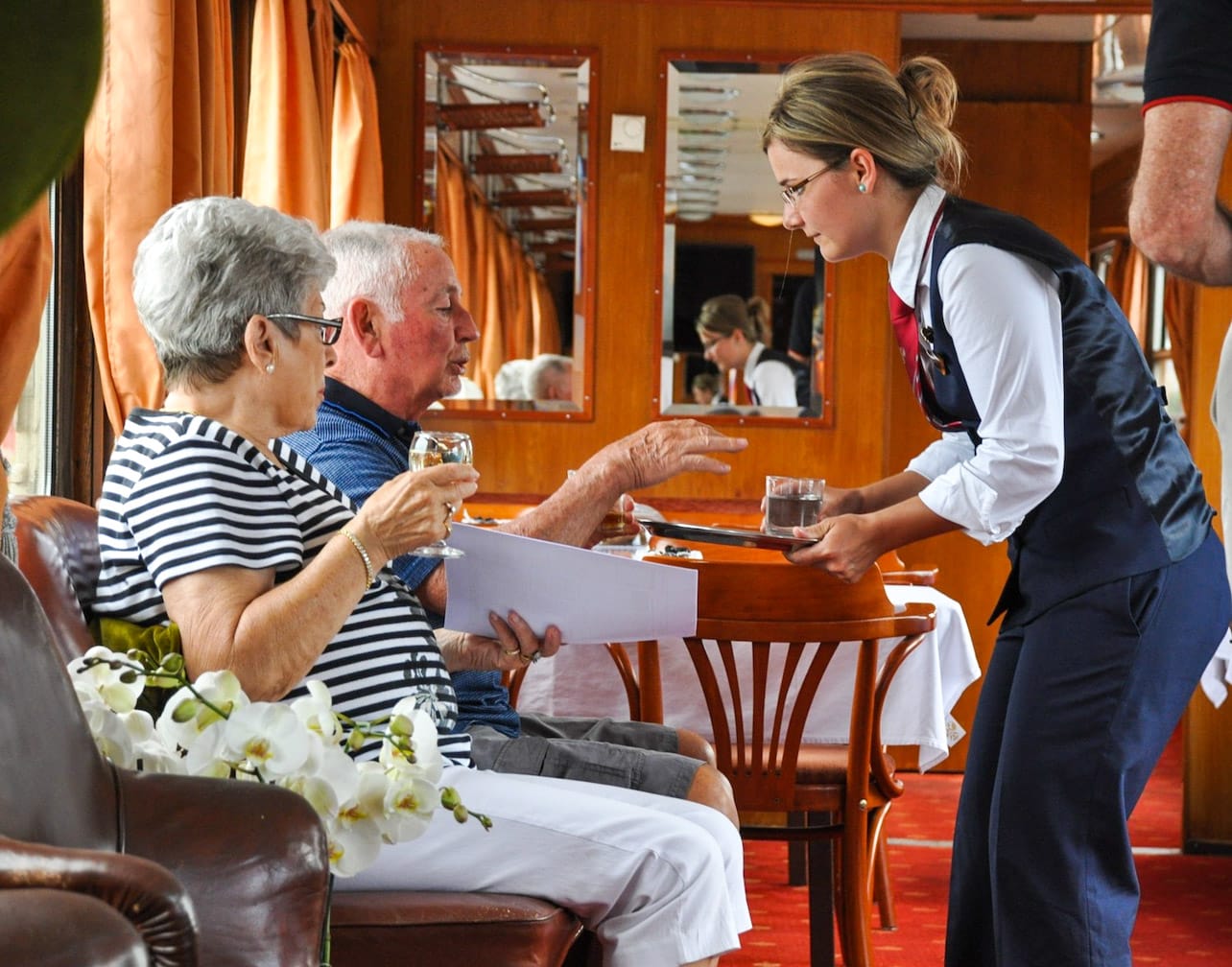 Guests enjoying the lounge car on the Golden Eagle Danube Express.