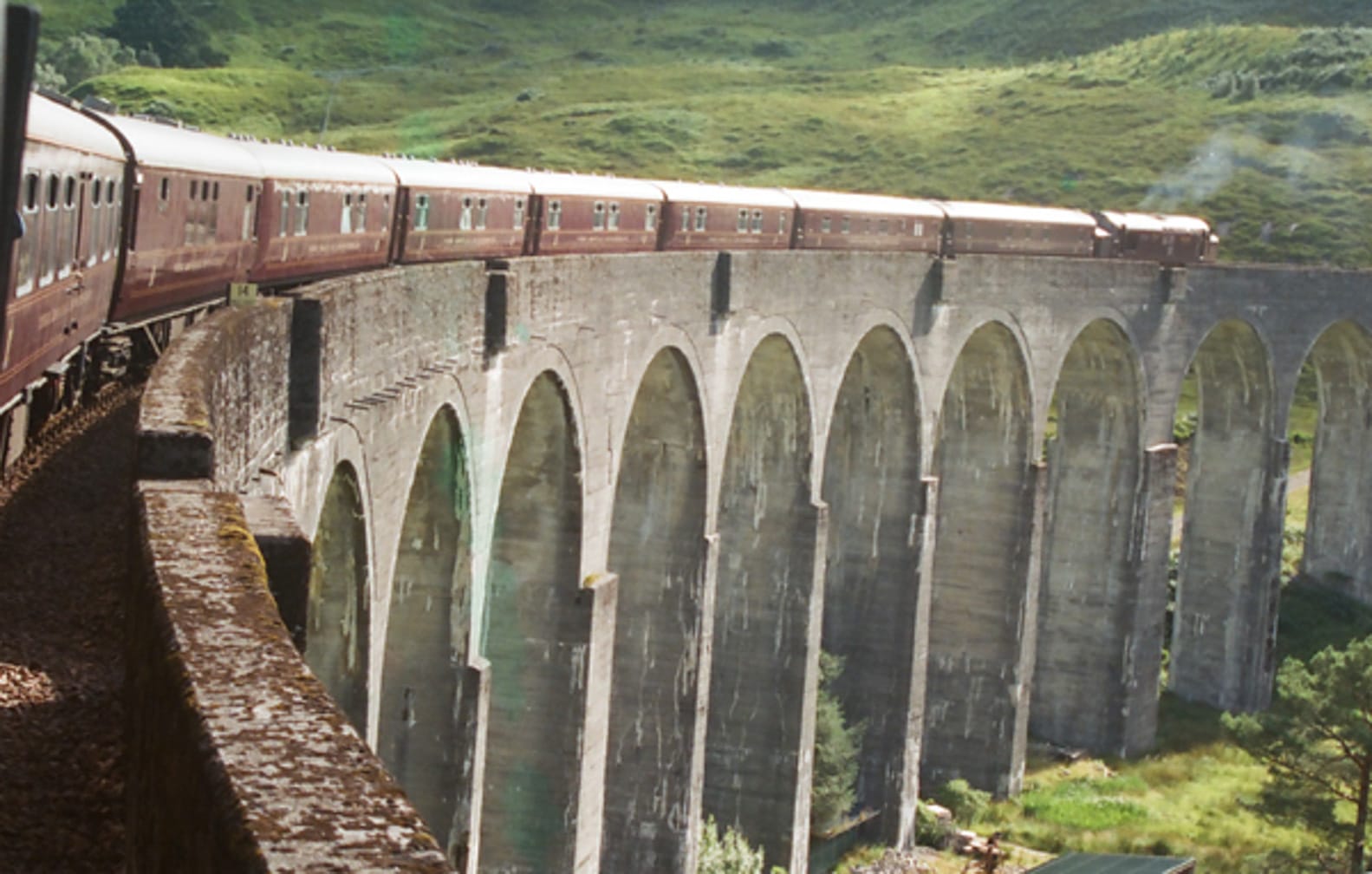 Train going across bridge on the Grand Taste of the Highlands journey