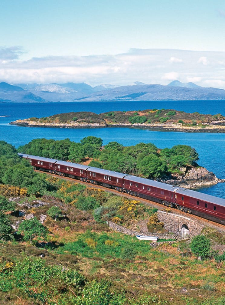 View of the water and train on the Grand Taste of the Highlands journey