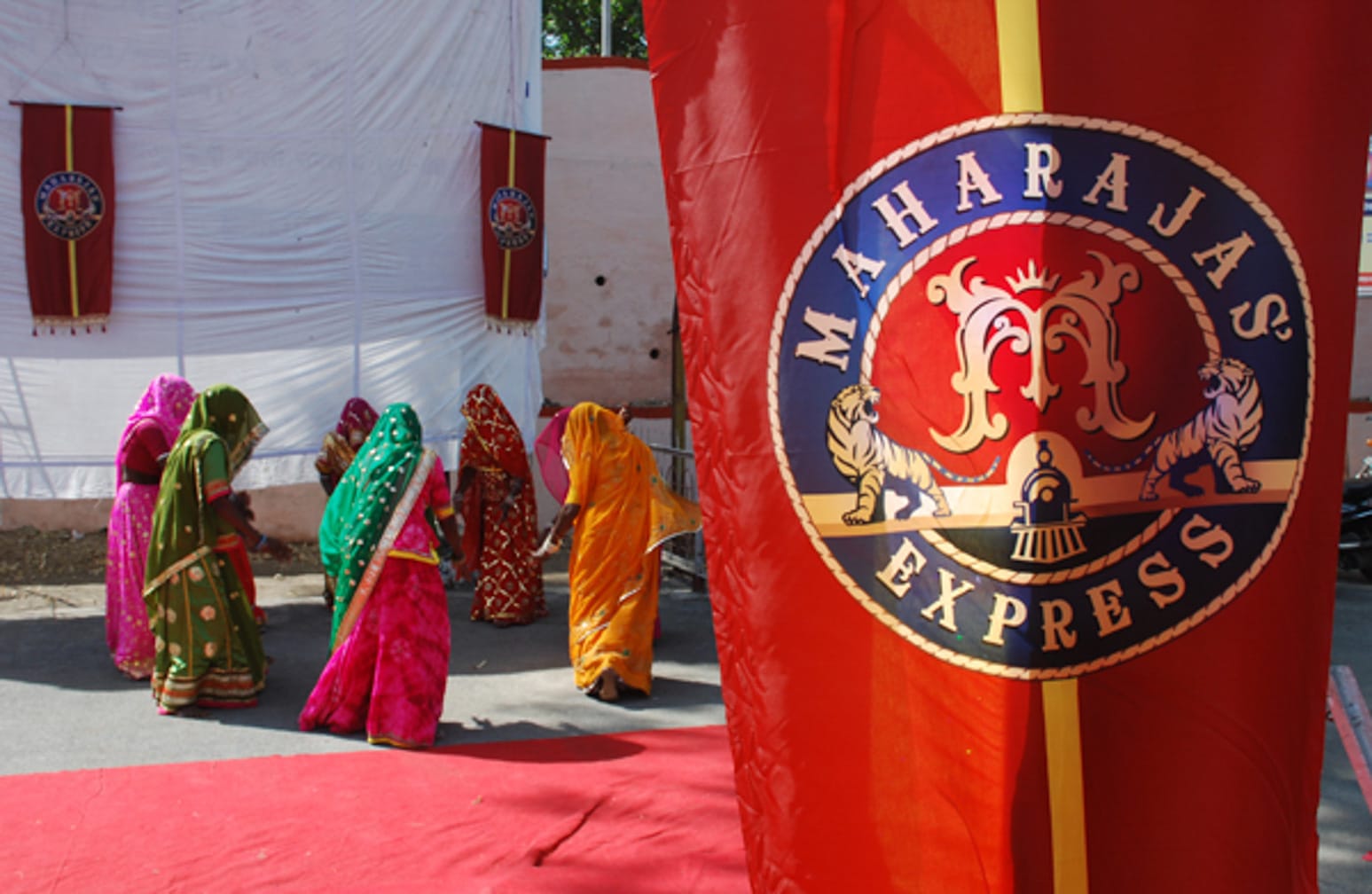 Flag with women in the background on the Maharajas' Express Indian Splendor, Delhi-Mumbai journey