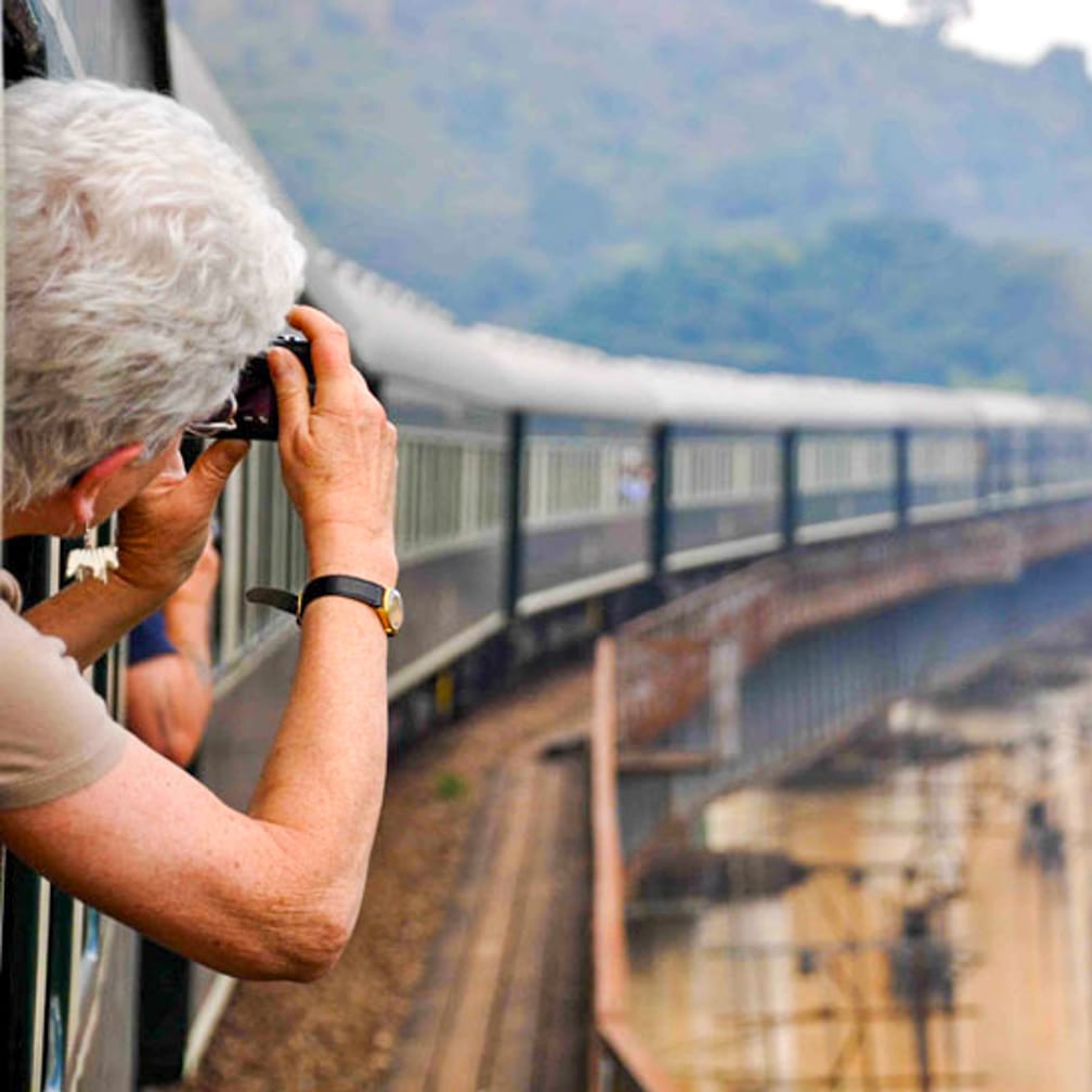 woman taking photos on the Rovos Rail The Ultimate Luxury Trek, Cape Town-Dar es Salaam journey