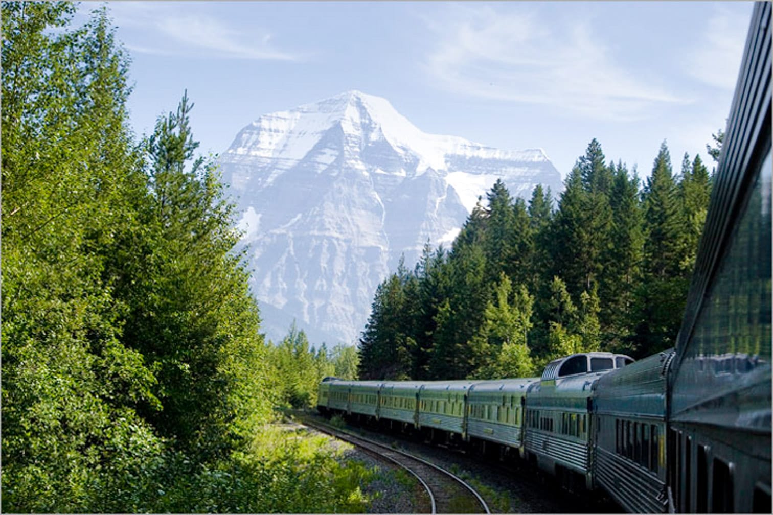 Train going through mountains on the Trans-Canada Rail Adventure: Vancouver-Toronto journey