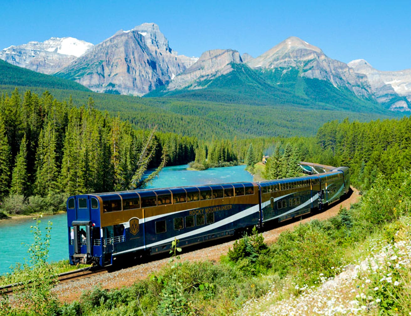 Train going through mountains on the Trans-Canada Rail Adventure: Vancouver-Toronto journey