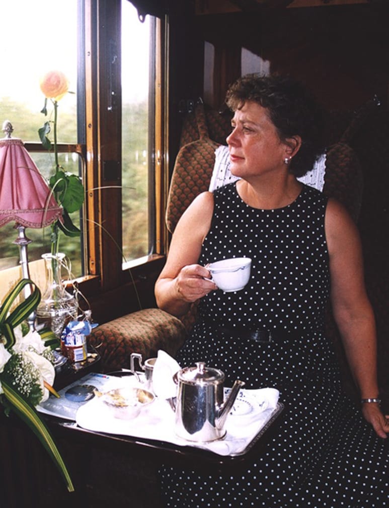 Woman drinking tea on the London-Paris-Venice journey