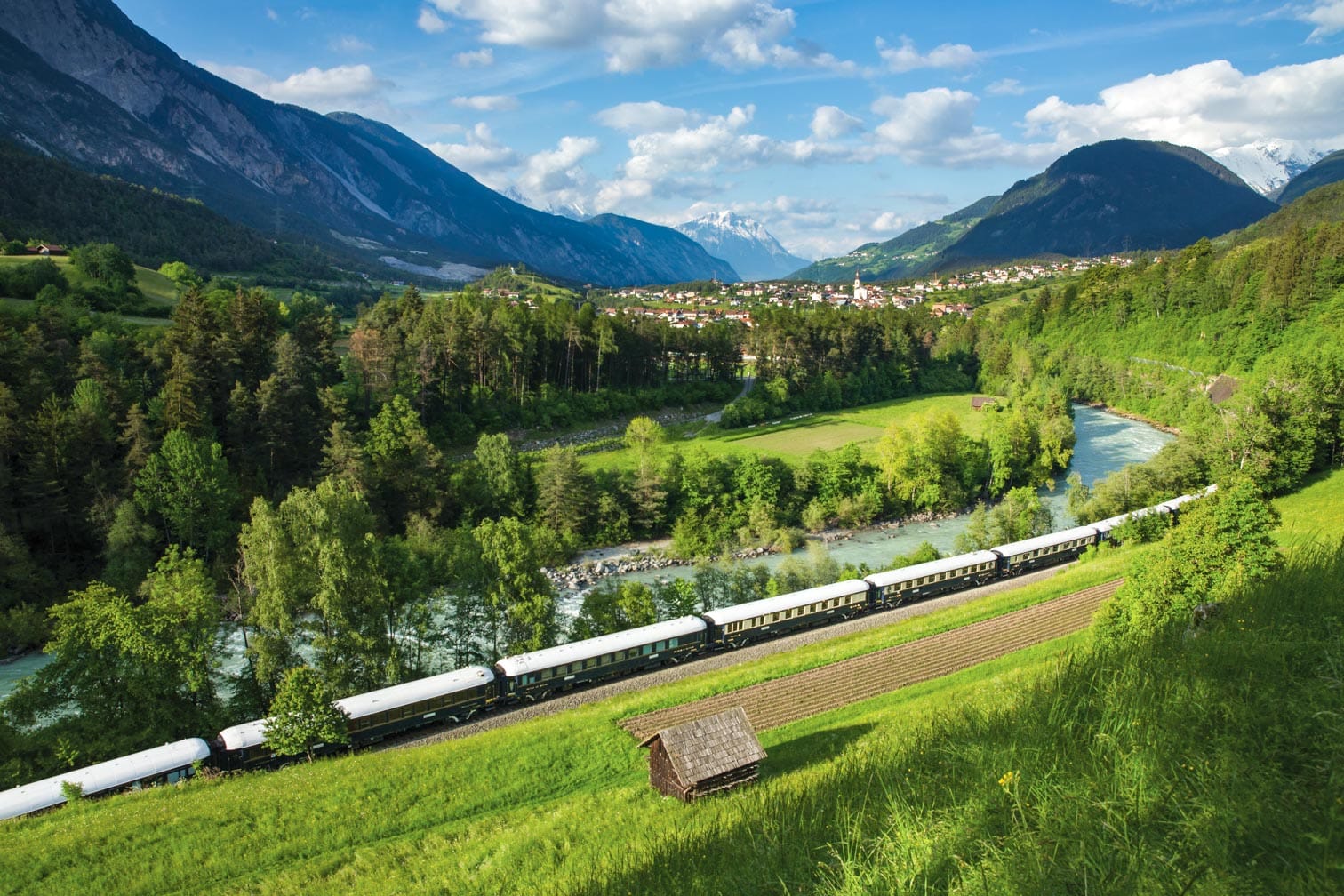 Aerial of the train going past mountains on the Venice-Vienna-Paris-London journey