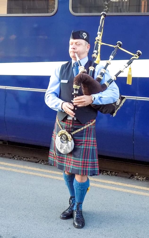 Man playing bagpipes on the Rocky Mountaineer: Ultra-Luxe Canadian Rockies Adventure journey