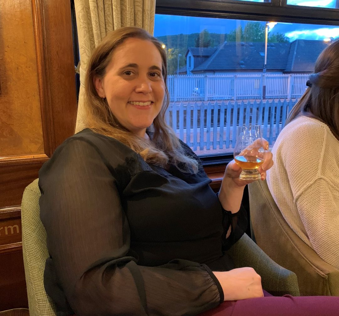 Woman on train drinking whisky