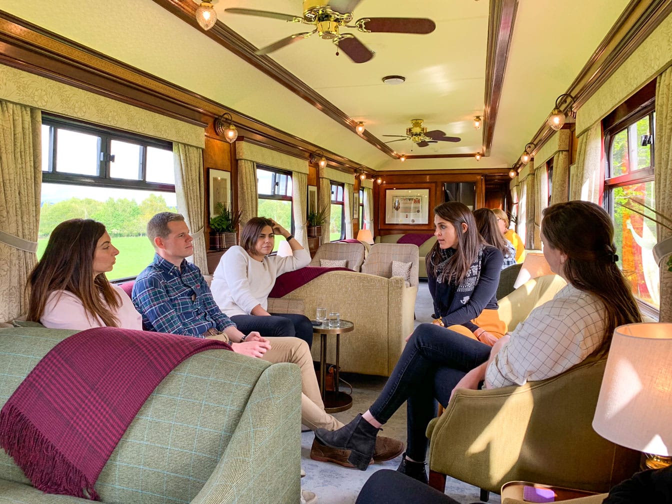 Guests talking in a car on the Belmond Royal Scotsman train