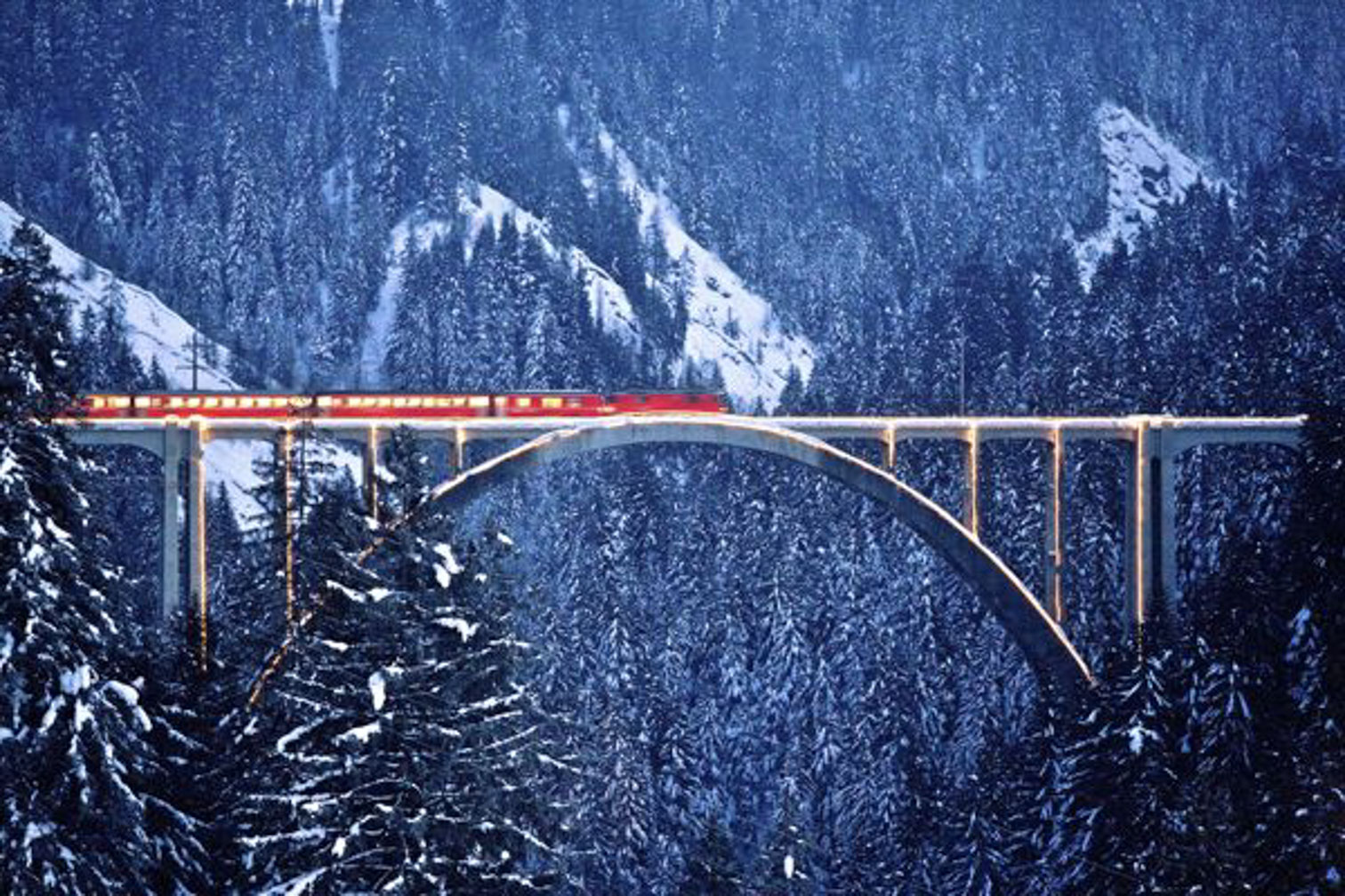 The Bernina Express at dusk. Nothing beats a visit to the snug, warmly lit dining car as stars twinkle in the darkening sky.