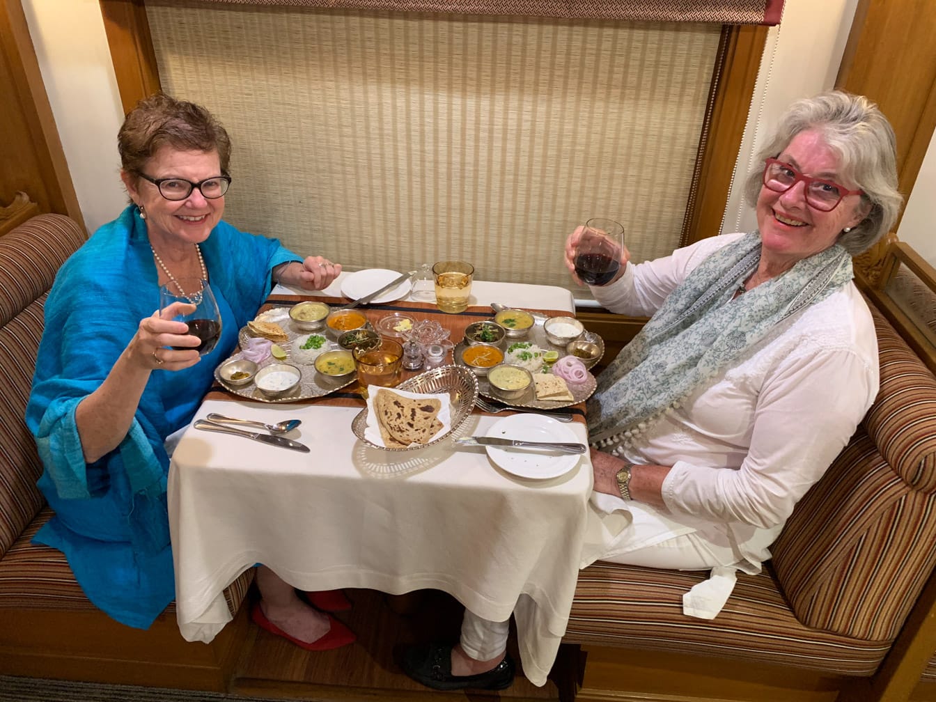 Two women eating an Indian meal on the Deccan Odyssey train