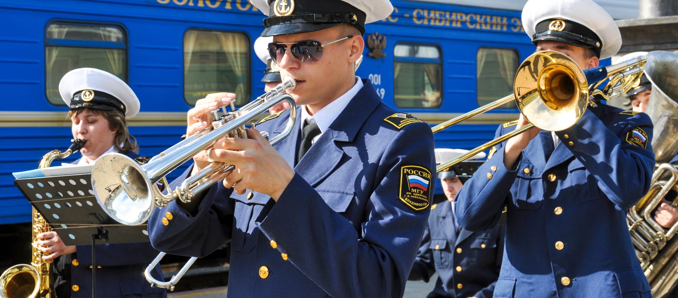 Military band performing by the Golden Eagle train