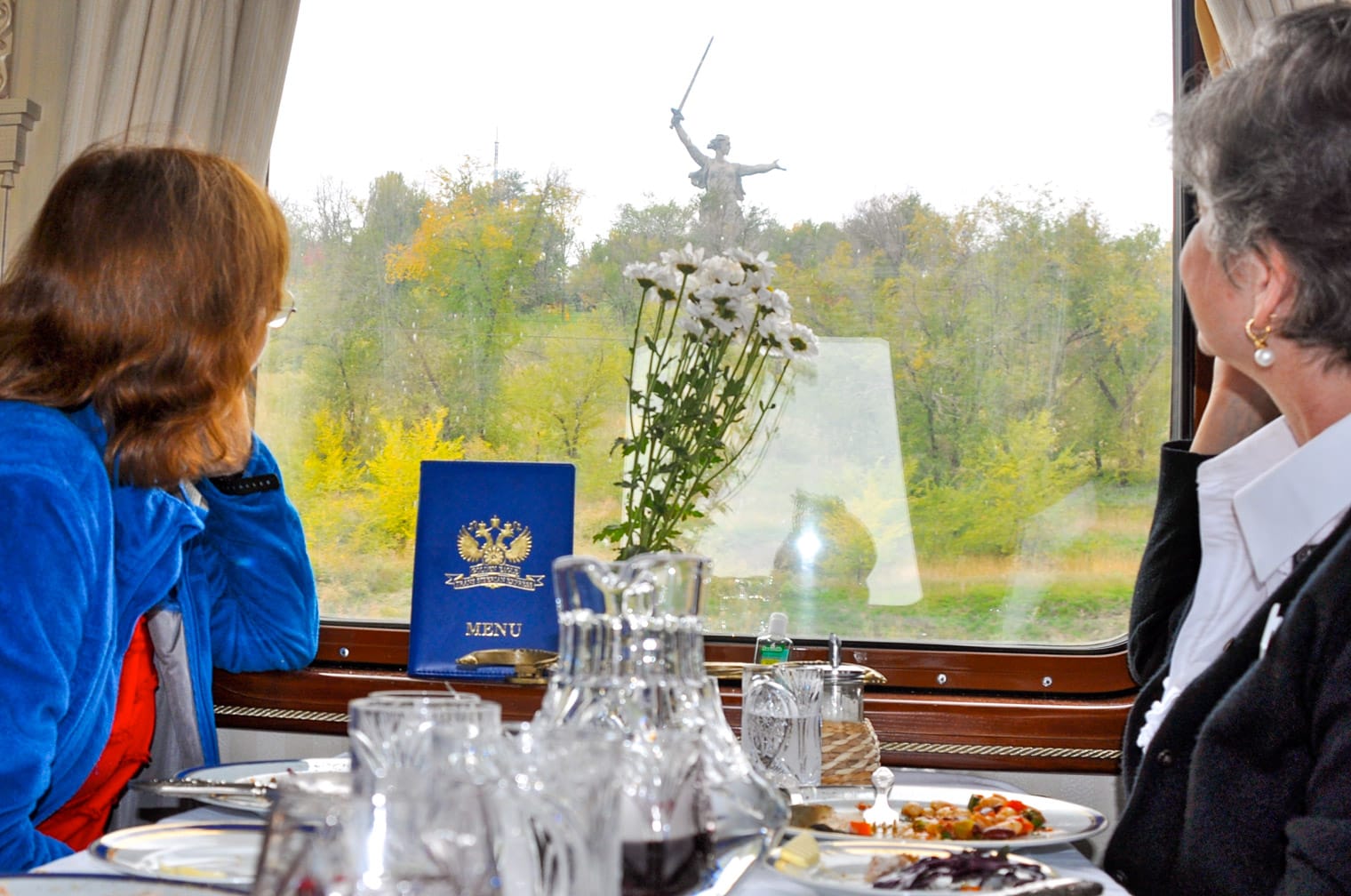 Two women looking out the window on the Golden Eagle train