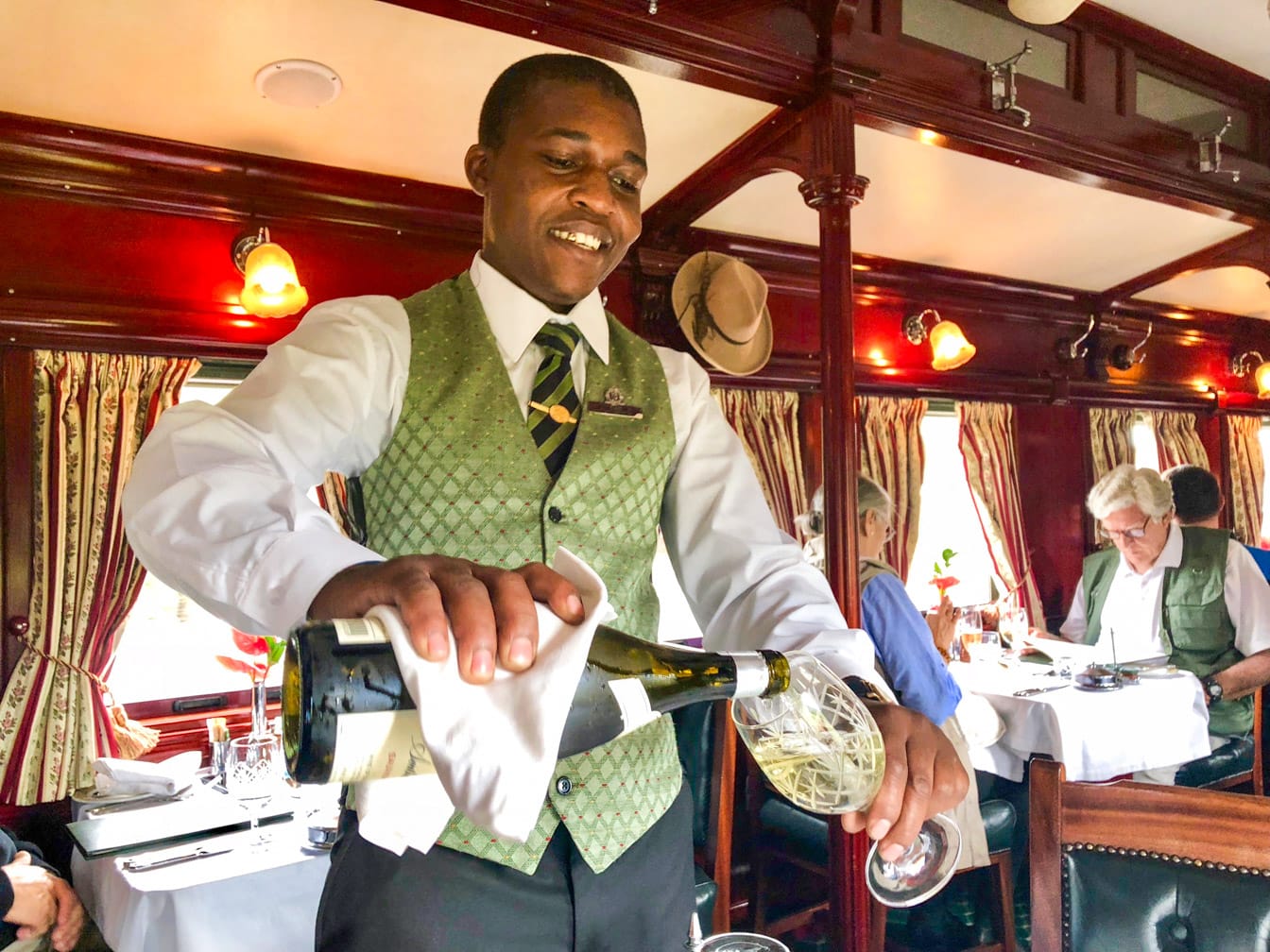 Server pouring drinks on the Rovos Rail Pride of Africa train