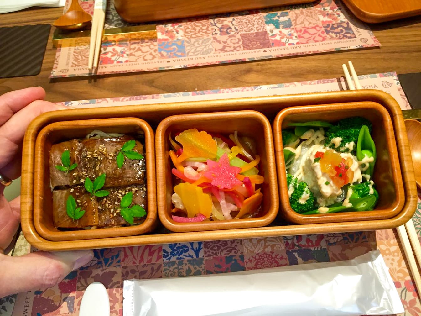 Three dishes with food on The Sweet Train