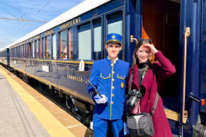 Staff and guest outside the Venice Simplon-Orient-Express (VSOE) train